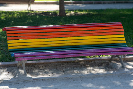 A bench in a city park painted in LGBT colorsの写真素材