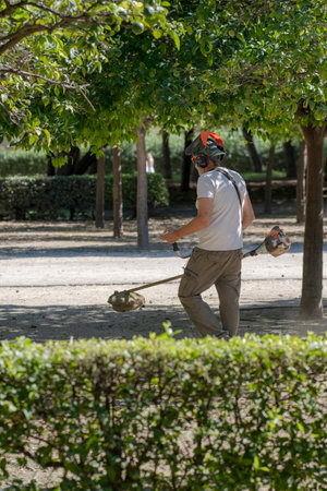 a worker with a hand-held lawn