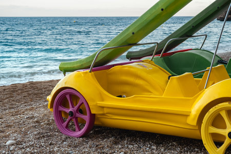 Slide for sliding into the water on the beach in the form of a bright yellow carの写真素材