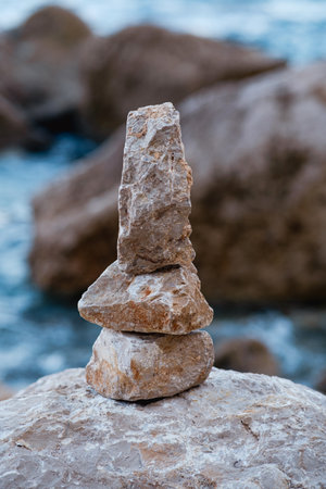 On the beach there are pyramids of stones made by manの写真素材