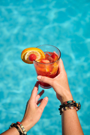 womens hands with a glass of cocktailの写真素材