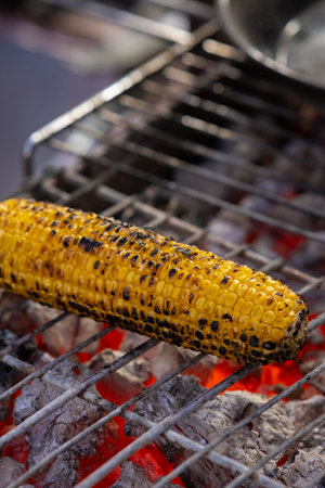 One corn pack is cooked on charcoalの写真素材