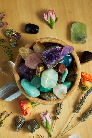 various gem stones in a wooden bowl top view