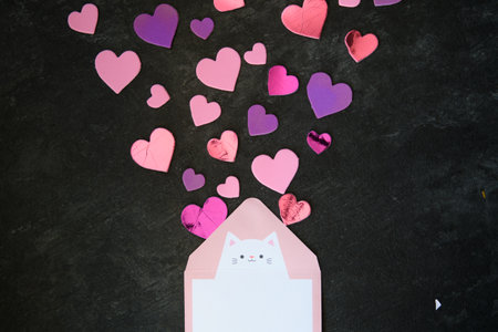 An envelope with the inscription Love lies on multi-colored hearts