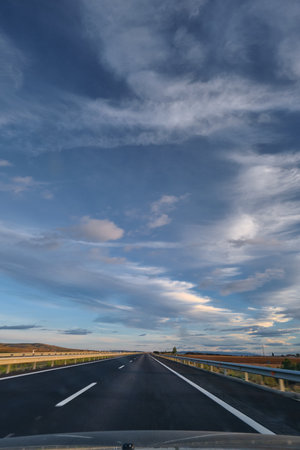 Highway stretching into the horizon, beautiful sky road tripの写真素材
