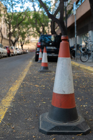 white-red construction cone on the roadの写真素材