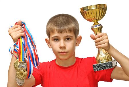 Boy-athlete with medals. Isolated on white background.の写真素材