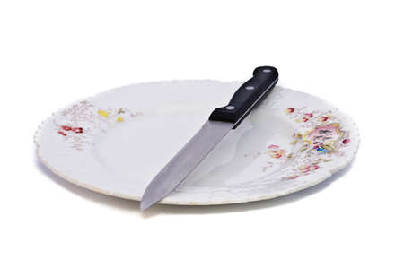 Plate and a knife. Objects on a white background.の写真素材