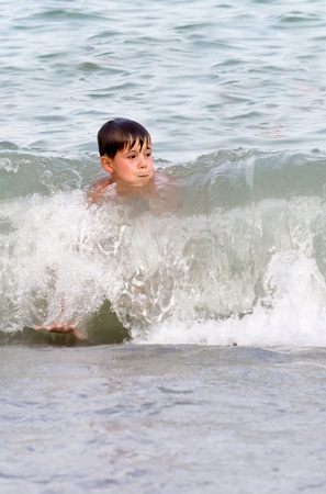 Boy playing in the surf. summer seaのeditorial素材