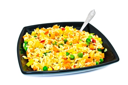 Black square plate with salad from rice and vegetables. Isolated on a white backgroundの写真素材