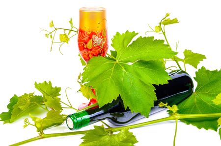 Bottle of red wine. The photo on the background of grape leavesの写真素材