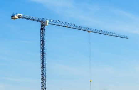 Construction crane. The photo on the background of blue sky