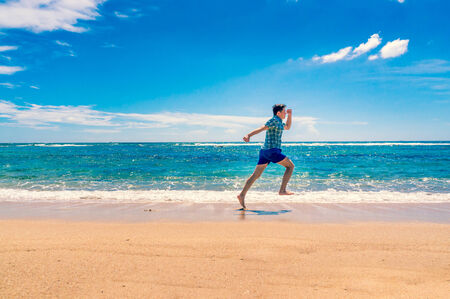 Young man enjoying freedom on the ocean. Summer holiday and vacation conceptの写真素材