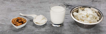 Milk, sour cream, cottage cheese and nuts for Breakfast on the concrete.の写真素材