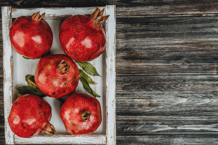 pomegranates in a light wooden boxの写真素材