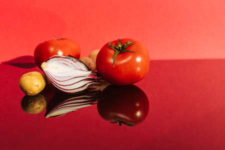 red onions, tomatoes and potatoes with a place for the textの写真素材