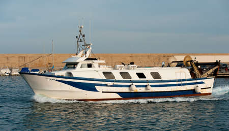 the fishing boat returns to port after a hard work dayの写真素材