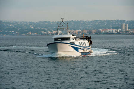the fishing boat returns to port after a hard work dayの写真素材