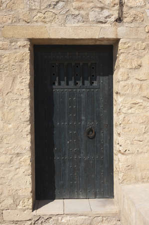 Antique wooden door in a mediterranean castleの写真素材