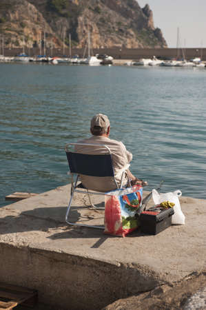 Fisherman waiting in Javea, Spainの写真素材
