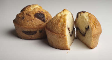Muffins with chocolate on a wooden tableの写真素材