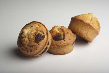 Muffins with chocolate on a wooden tableの写真素材