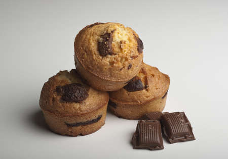 Muffins with chocolate on a wooden tableの写真素材