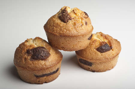 Muffins with chocolate on a wooden tableの写真素材