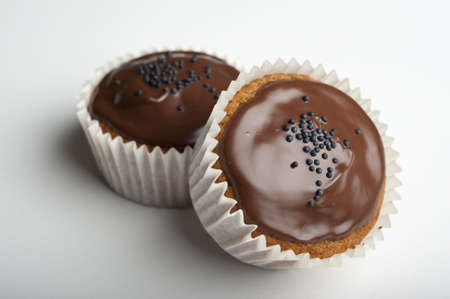 Muffins with chocolate on a wooden tableの写真素材