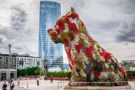 BILBAO, SPAIN - OCTOBER 1  Iberdrola Tower and Puppy sculpture on October 1, 2013 in Bilbao, Spain  The tower was designed by architect Caesar Pelli and the Puppy sculpture by Jeff Koonsのeditorial素材