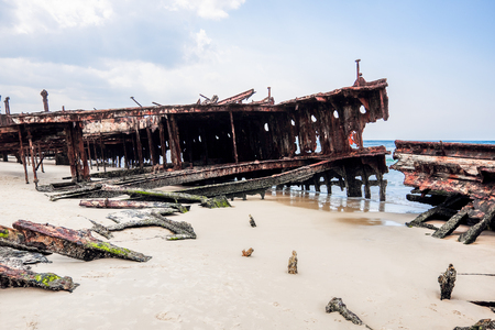 straded ship on the white sanded beachの写真素材
