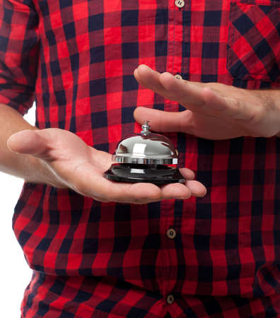 Young man over white background. Using a hotel bellの写真素材