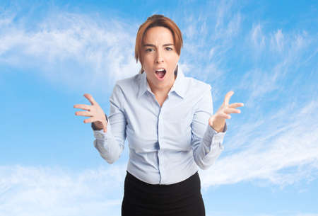 Business woman over clouds background. Looking upsetの写真素材