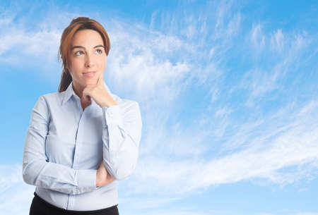 Business woman over clouds background. Looking cuteの写真素材