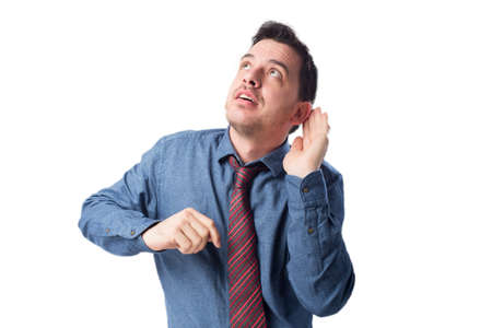 Man wearing a blue shirt and red tie. He is paying attentionの写真素材