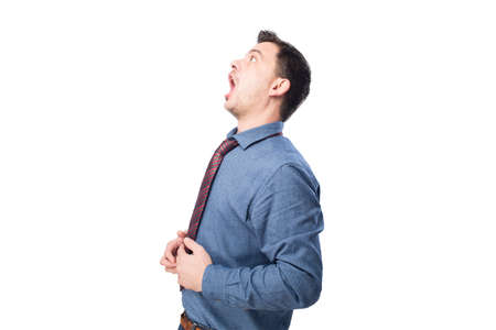 Man wearing a blue shirt and red tie. He is looking surprisedの写真素材