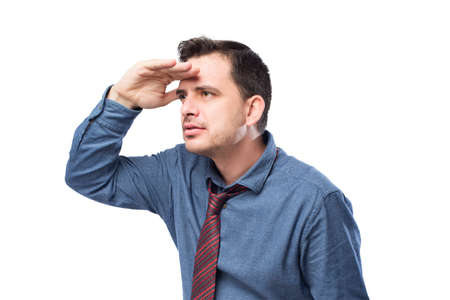 Man wearing a blue shirt and red tie. He is looking surprised to the horizonの写真素材