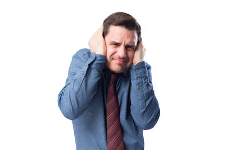 Man wearing a blue shirt and red tie. He is upset because of the noiseの写真素材