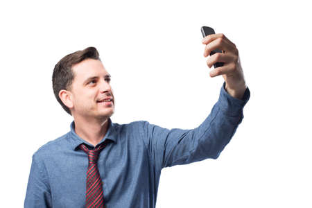 Man wearing a blue shirt and red tie. He is taking a selfie