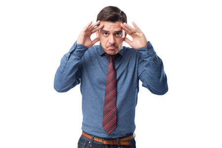 Man wearing a blue shirt and red tie. He is looking upsetの写真素材