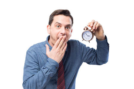 Man wearing a blue shirt and red tie. He is holding a clock