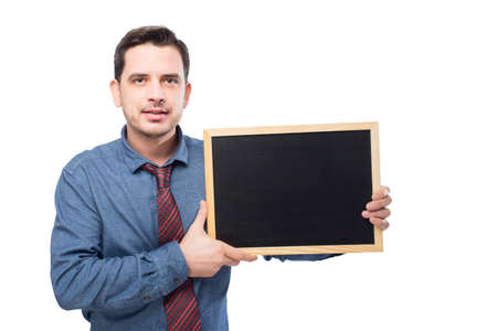 Man wearing a blue shirt and red tie. He is holding a blackboardの写真素材