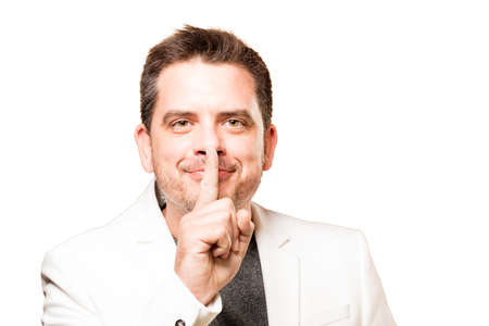 Man wearing a white jacket. Doing silence gesture.