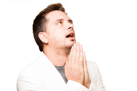 Man wearing a white jacket. Praying.