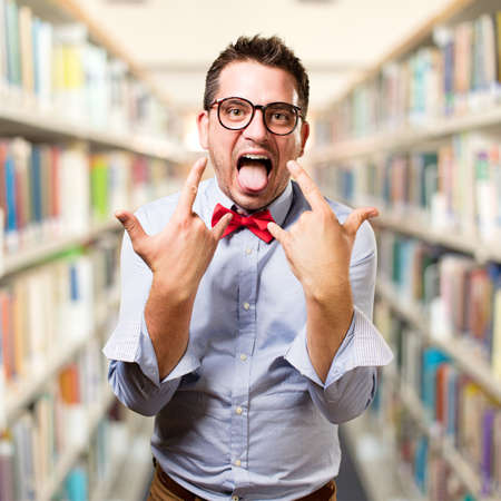 Man wearing a red bow tie. Rocker gesture.の写真素材