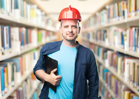 Young man wearing a blue outfit. Wearing red helmet.