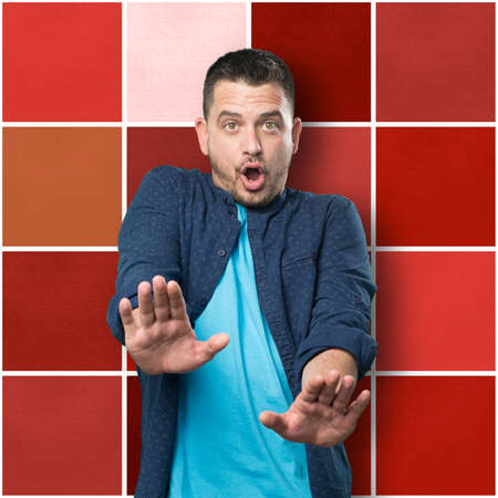 Young man wearing a blue outfit. looking afraid.の写真素材