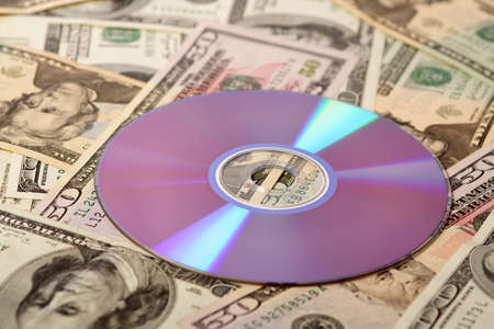 Closeup of DVD on money background. Shallow DOF.の写真素材
