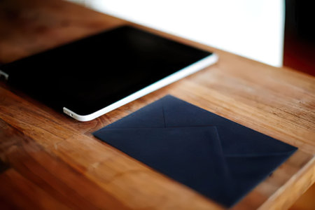 Blank business card and tablet on a wooden table in the office