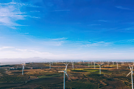 Wind turbines generating electricity in a wind farm with blue sky in Thailand